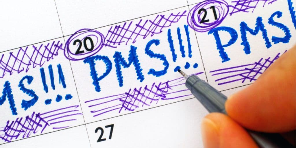 Menstrual mood swings: calendar where a woman writes: ‘PMS’ on all days