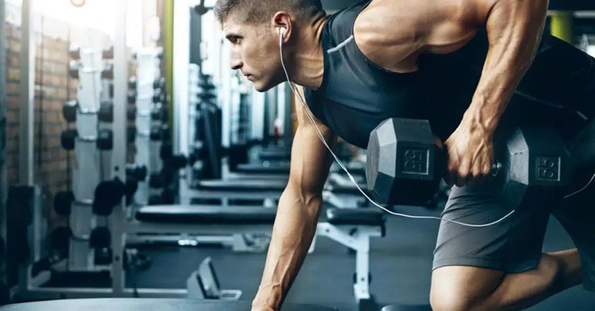 Man who builds muscle by training with dumbbells